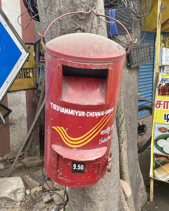 Red India Post letter box on a tree in Chennai